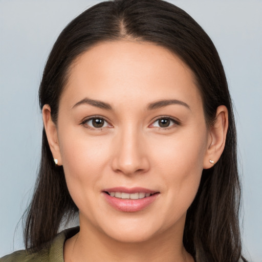 Joyful white young-adult female with long  brown hair and brown eyes