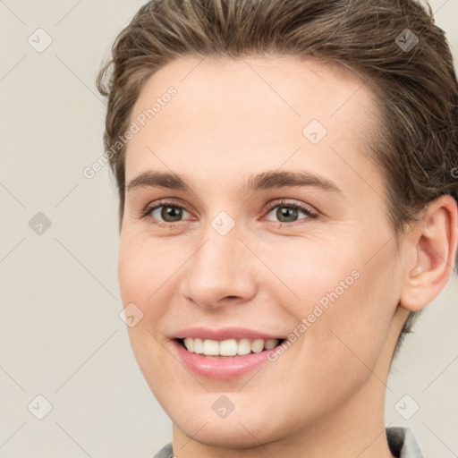 Joyful white young-adult female with short  brown hair and brown eyes