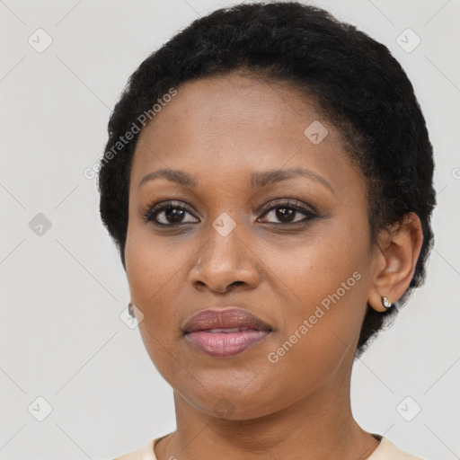 Joyful black young-adult female with short  black hair and brown eyes