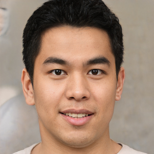 Joyful asian young-adult male with short  brown hair and brown eyes