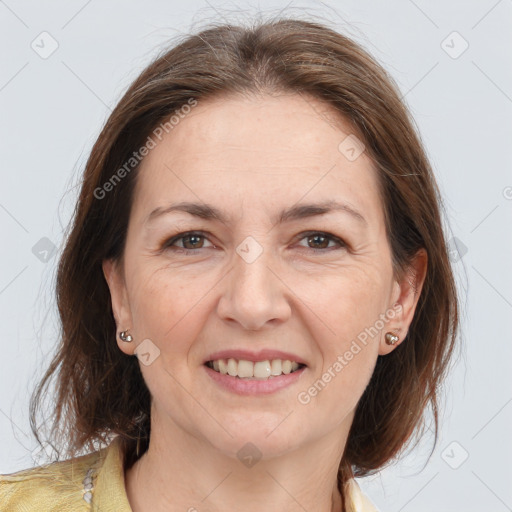 Joyful white adult female with medium  brown hair and brown eyes