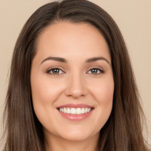 Joyful white young-adult female with long  brown hair and brown eyes