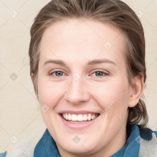 Joyful white young-adult female with medium  brown hair and blue eyes