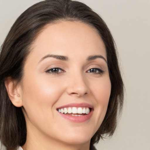 Joyful white young-adult female with medium  brown hair and brown eyes