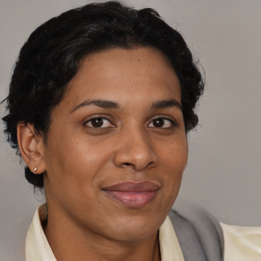 Joyful latino adult female with short  brown hair and brown eyes