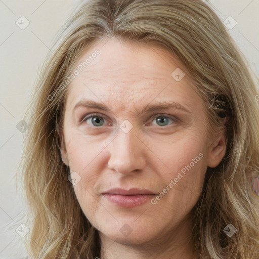 Joyful white adult female with long  brown hair and green eyes