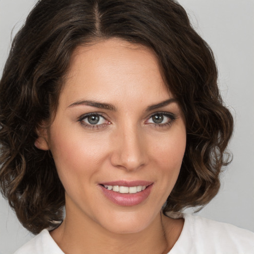 Joyful white young-adult female with medium  brown hair and brown eyes