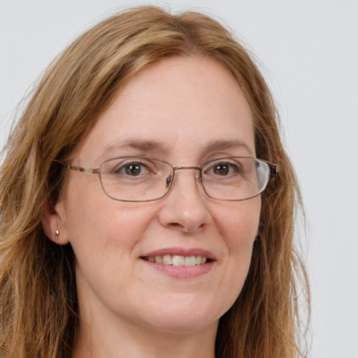 Joyful white adult female with long  brown hair and blue eyes