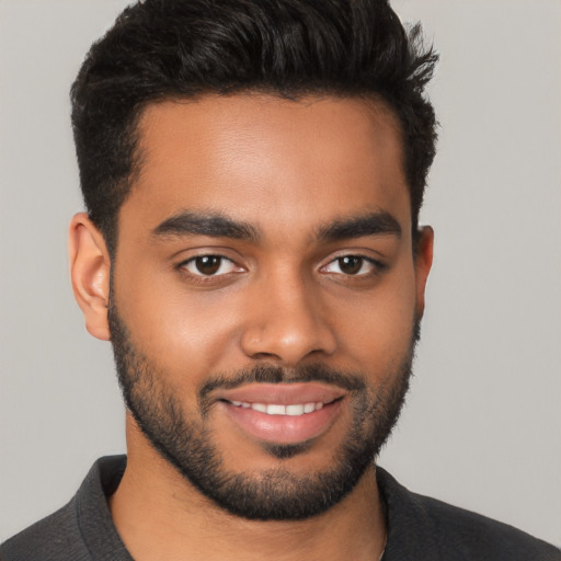 Joyful latino young-adult male with short  black hair and brown eyes