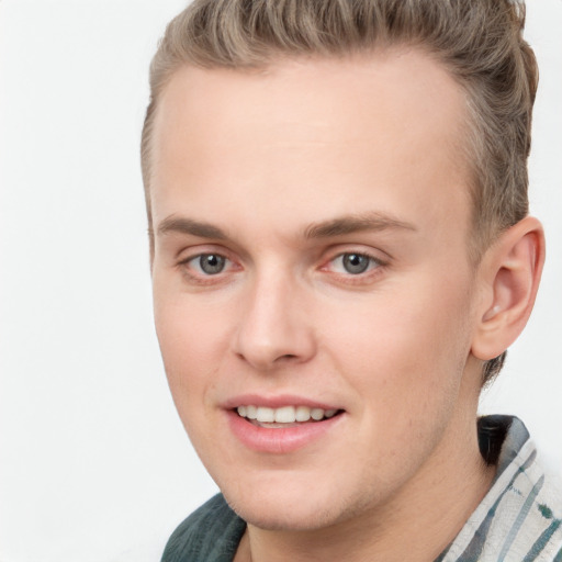 Joyful white young-adult male with short  brown hair and blue eyes