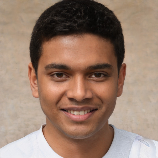 Joyful white young-adult male with short  black hair and brown eyes