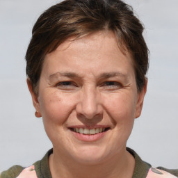 Joyful white adult female with short  brown hair and brown eyes