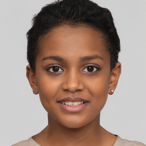 Joyful black young-adult female with short  brown hair and brown eyes