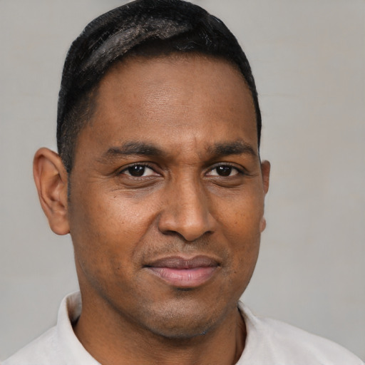Joyful latino adult male with short  brown hair and brown eyes