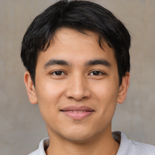 Joyful asian young-adult male with short  black hair and brown eyes