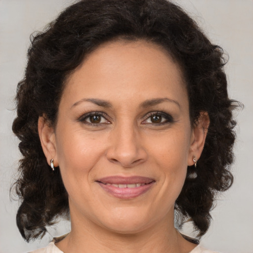 Joyful black adult female with medium  brown hair and brown eyes
