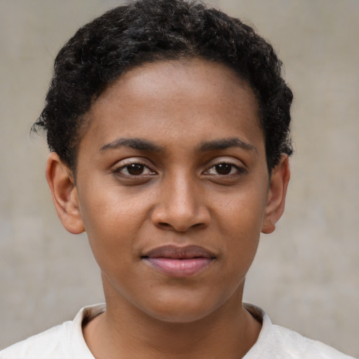 Joyful black young-adult female with short  brown hair and brown eyes
