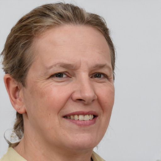 Joyful white adult female with short  brown hair and grey eyes