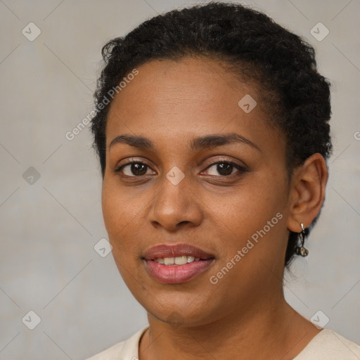 Joyful black young-adult female with short  brown hair and brown eyes