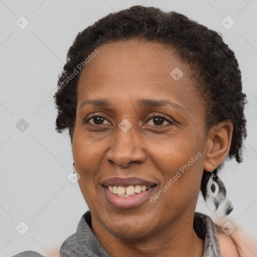 Joyful black adult female with short  brown hair and brown eyes