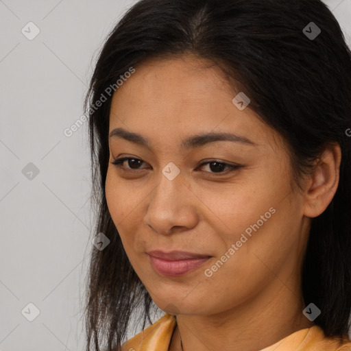Joyful latino young-adult female with long  brown hair and brown eyes