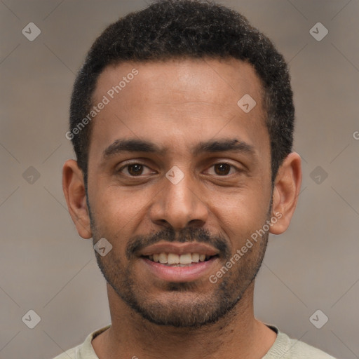 Joyful black young-adult male with short  black hair and brown eyes