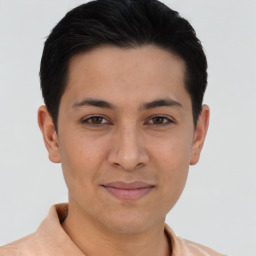 Joyful latino young-adult male with short  brown hair and brown eyes