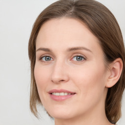 Joyful white young-adult female with long  brown hair and blue eyes