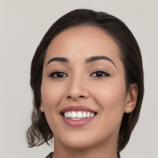 Joyful white young-adult female with medium  brown hair and brown eyes