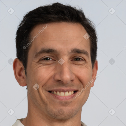 Joyful white adult male with short  brown hair and brown eyes