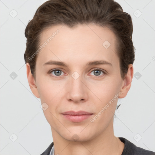 Joyful white young-adult female with short  brown hair and grey eyes