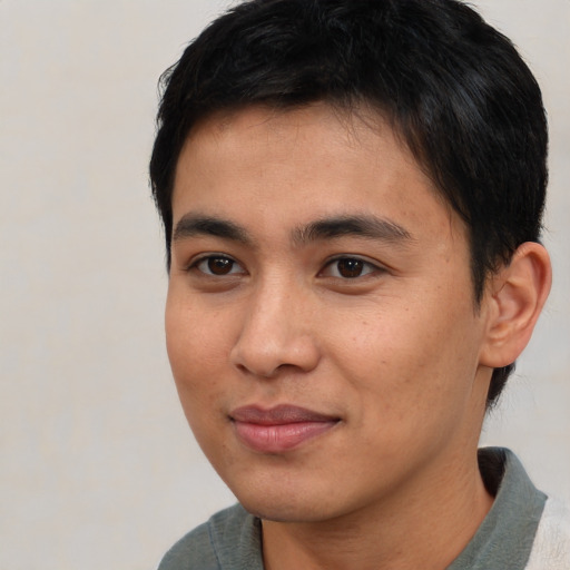 Joyful asian young-adult male with short  brown hair and brown eyes