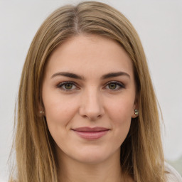 Joyful white young-adult female with long  brown hair and green eyes