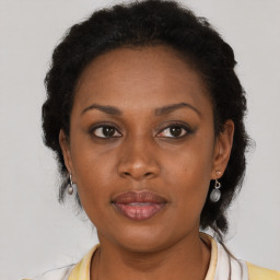 Joyful black adult female with short  brown hair and brown eyes