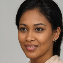 Joyful black young-adult female with long  brown hair and brown eyes