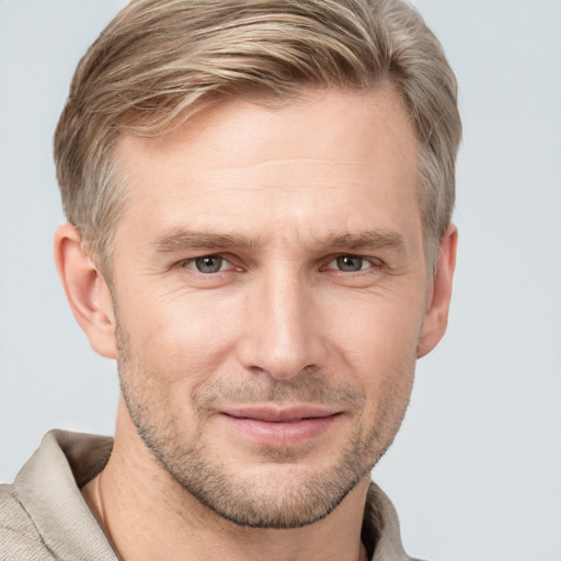 Joyful white adult male with short  brown hair and grey eyes