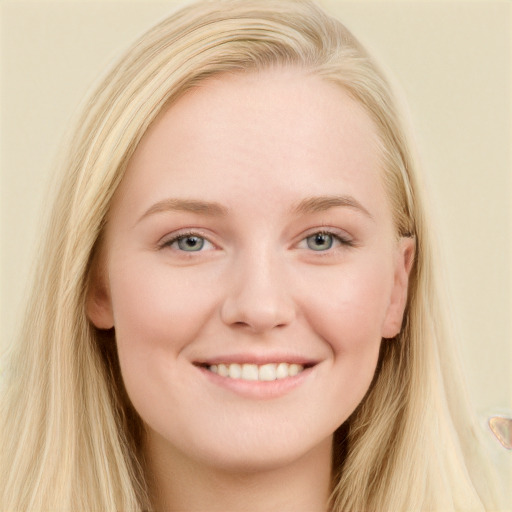 Joyful white young-adult female with long  brown hair and blue eyes