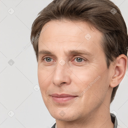 Joyful white adult male with short  brown hair and grey eyes