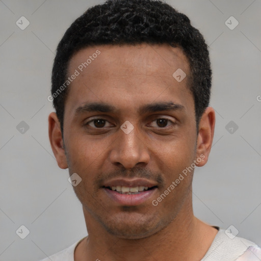 Joyful black young-adult male with short  black hair and brown eyes