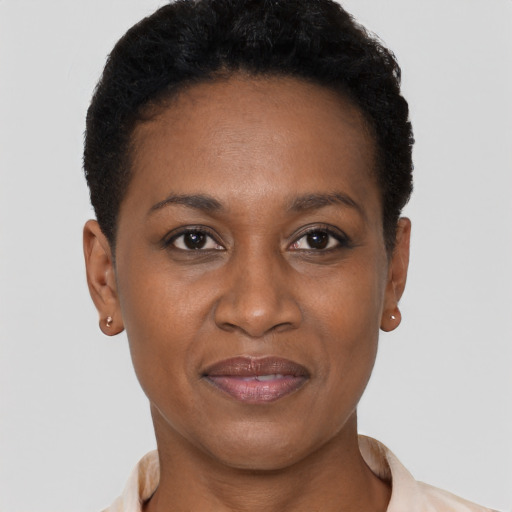 Joyful black young-adult female with short  black hair and brown eyes