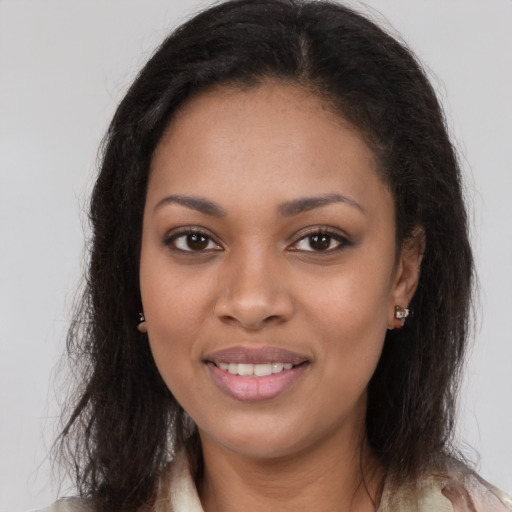 Joyful black young-adult female with long  brown hair and brown eyes
