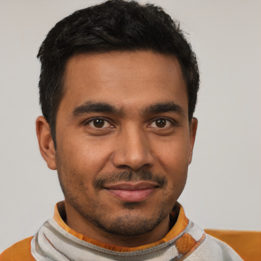 Joyful latino young-adult male with short  black hair and brown eyes