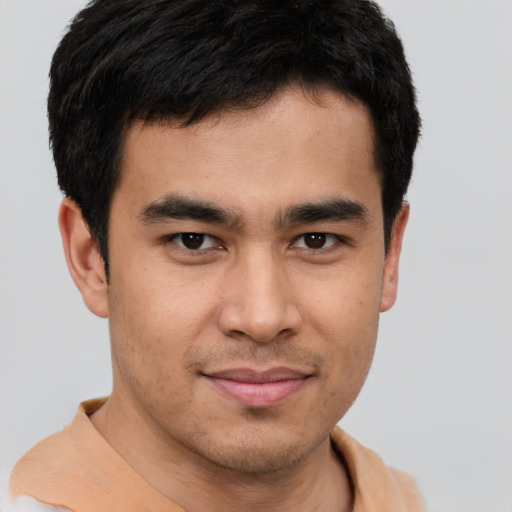 Joyful latino young-adult male with short  brown hair and brown eyes