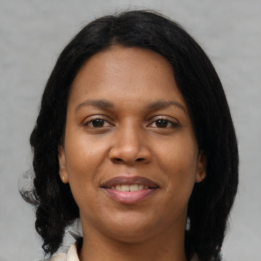 Joyful black young-adult female with medium  brown hair and brown eyes