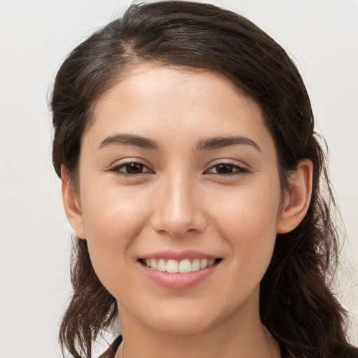 Joyful white young-adult female with long  brown hair and brown eyes