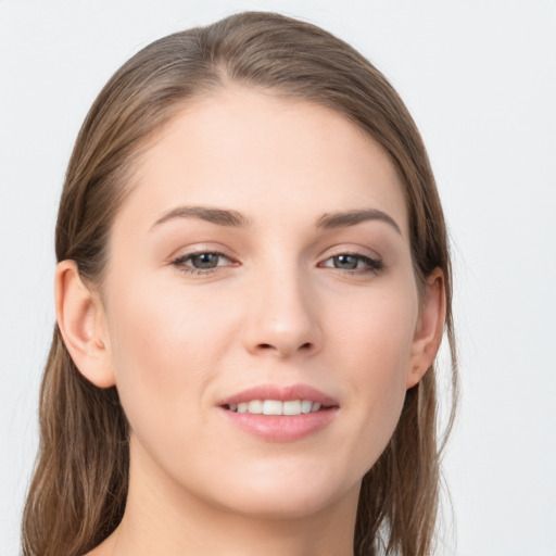 Joyful white young-adult female with long  brown hair and grey eyes