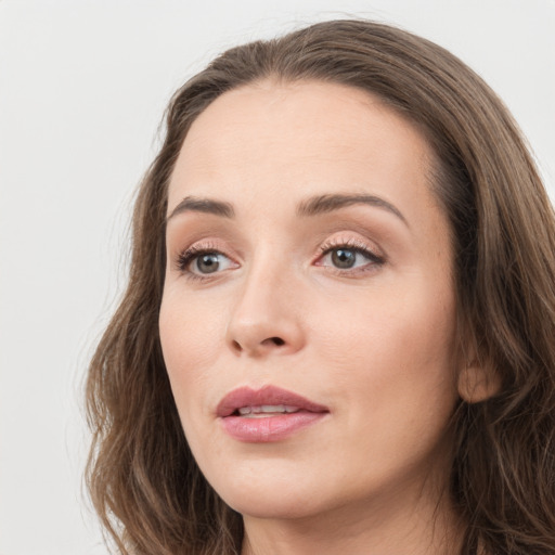 Joyful white young-adult female with long  brown hair and grey eyes