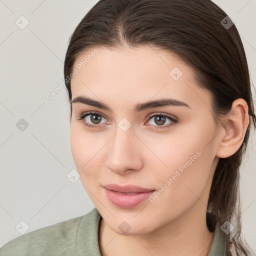 Joyful white young-adult female with long  brown hair and brown eyes