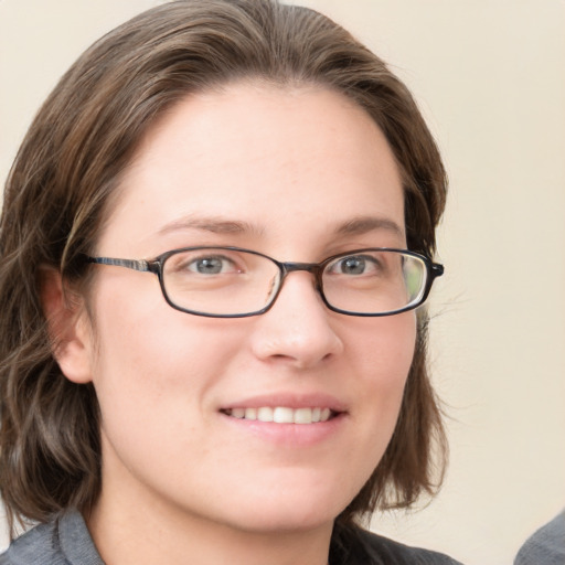 Joyful white young-adult female with medium  brown hair and blue eyes