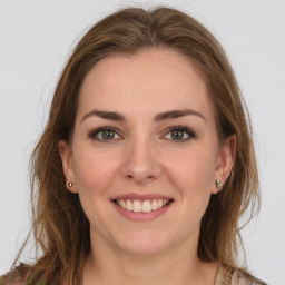 Joyful white young-adult female with long  brown hair and green eyes